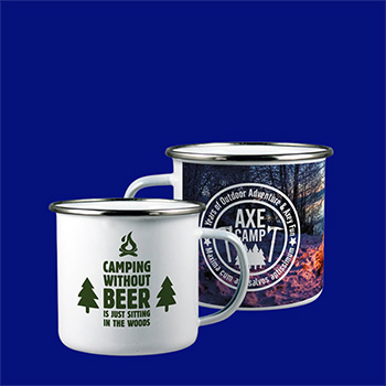 Two enamel mugs on a royal blue background. One mug is white with a green screen printed design whilst the other is full colour printed with a photo of a woodland in winter with a white text overprint.