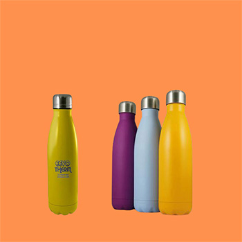 Four Eevo-Therm Thermal Bottles all with silver lids on a peach background. Three bottles are plain coloured; purple, babu blue and yellow whilst one is bright yellow with a grey etched logo in the centre of the bottle.